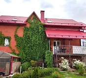 Кирпичный дом с красной крышей из металлочерепицы RAL 3011