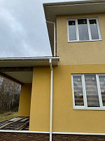 Двухэтажный жёлтый дом с белым водостоком Döcke Premium ПВХ