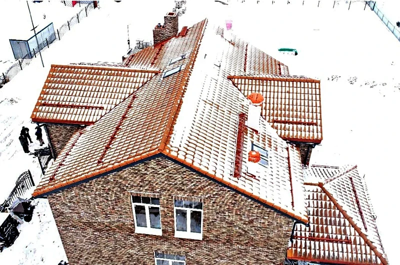 Укладка красной черепицы на скате крыши