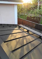 Фальцевая кровля Grand Line PurPro Matt с переходным мостиком на закате