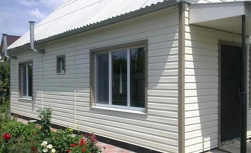 Частный дом с облицовкой металлосайдингом светлого цвета