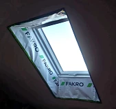 Окно FAKRO с защитной пленкой до завершения работ